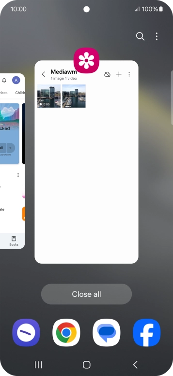 Press the first application and drag it to the top or bottom of the screen.