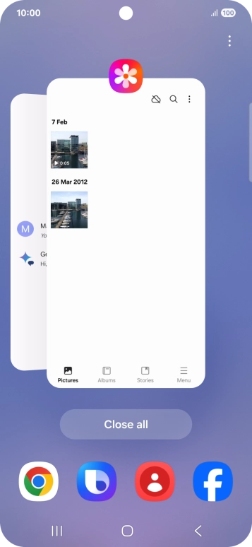Press the first application and drag it to the top or bottom of the screen.