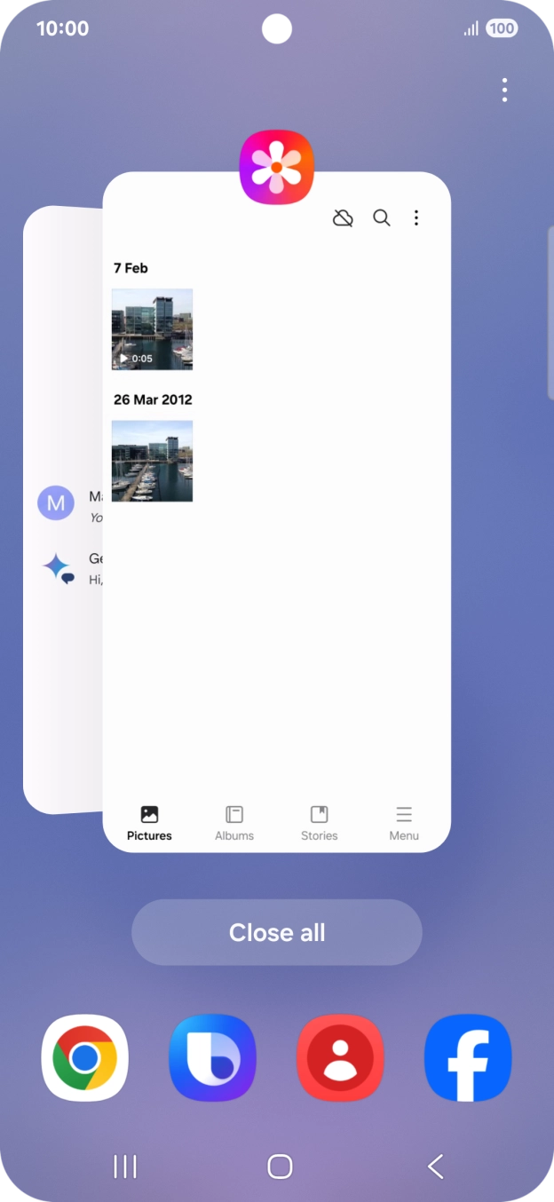 Press the first application and drag it to the top or bottom of the screen.