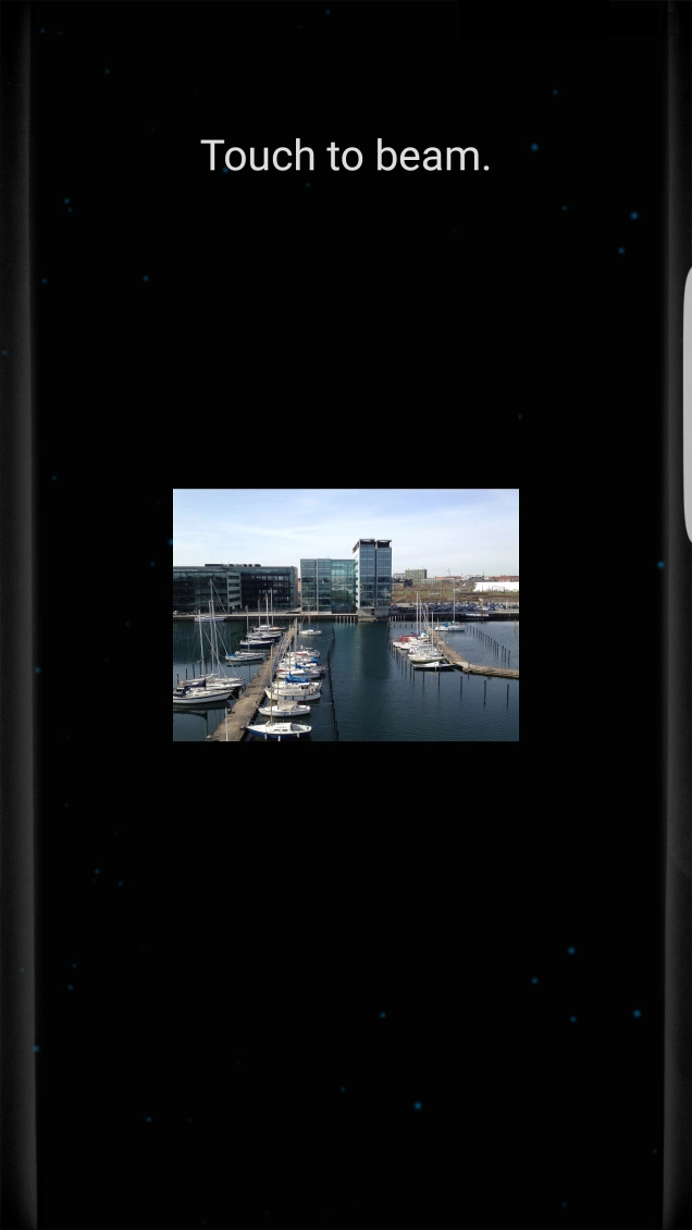 Hold the back of your phone close to back of the receiving device. Press Touch to beam. and wait while the file is transferred. Hold the back of your phone close to back of the receiving device. Press Touch to beam. and wait while the file is transferred.