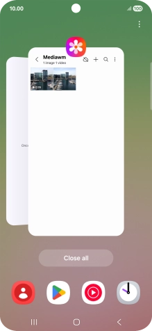 Press the first application and drag it to the top or bottom of the screen.