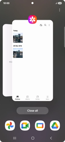Press the first application and drag it to the top or bottom of the screen.