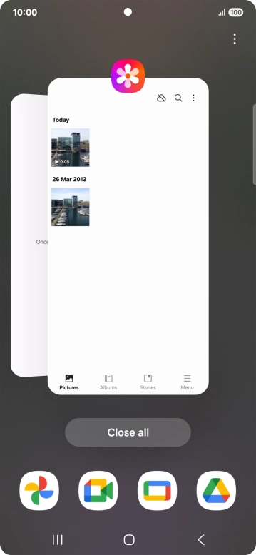 Press the first application and drag it to the top or bottom of the screen.