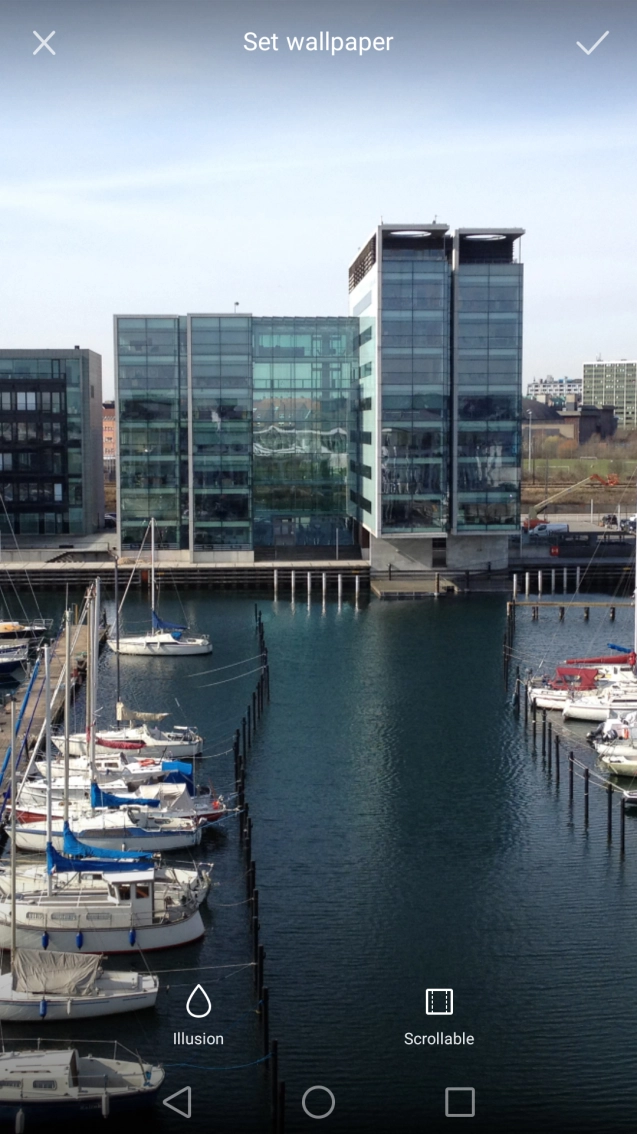 Drag two fingers together or apart to zoom in or out and press the confirm icon.