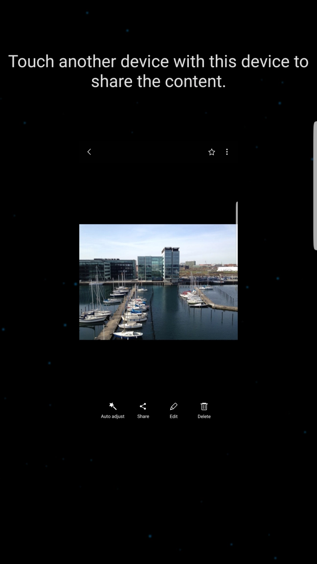 Hold the back of your phone close to back of the receiving device. Press Touch another device with this device to share the content and wait while the file is transferred.