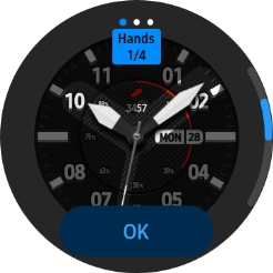 Slide your finger right or left on the screen and use the Rotating bezel to change between the different designs.