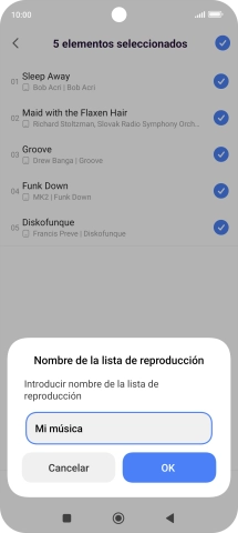 Introduce el nombre deseado de la lista de reproducción y pulsa OK.