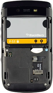 Take hold of the right side of the battery and remove it.