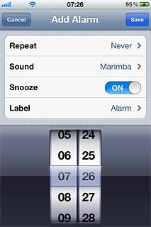 Drag the wheels to set the time for the alarm.