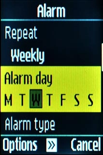 Scroll to Alarm day and press the Navigation key.