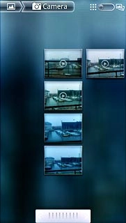 Go to the required folder.Press and hold the required picture or the required video clip to select it.