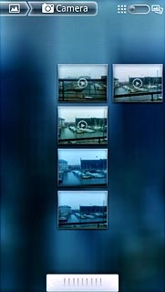 Go to the required folder.Press and hold the required picture or the required video clip to select it.