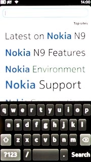 Press the address bar at the top of the display.