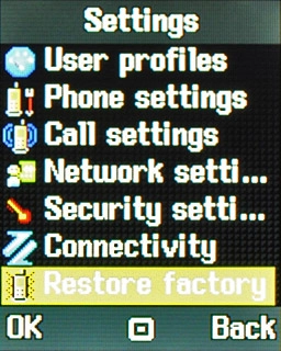 Scroll to Restore factory settings and press the Navigation key.