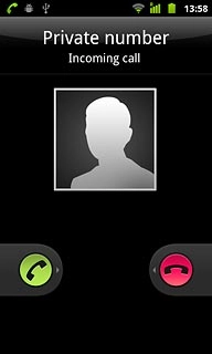 When you have an ongoing call, the new call is signalled by a sound.Press and drag the answer icon right.