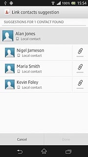 Press the merge icon next to the required contacts.
